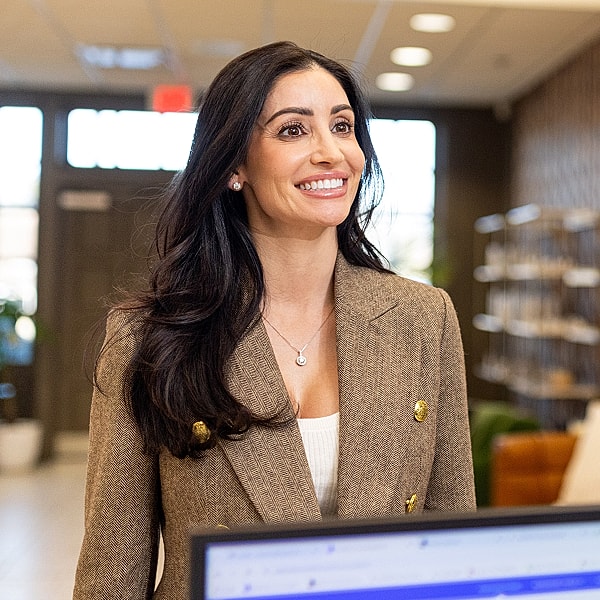 Smiling woman in a stylish office setting.