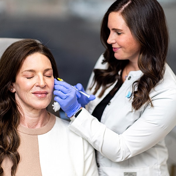 Woman receiving cosmetic treatment at a clinic.