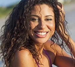 St. Louis Juvederm Ultra Plus model with curly hair at the beach.