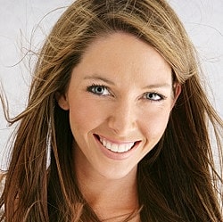 Smiling woman with long, flowing hair.
