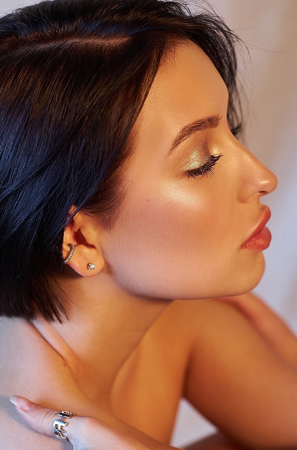 Profile of a woman with flawless makeup.
