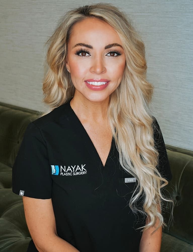 Smiling professional in a medical uniform portrait.