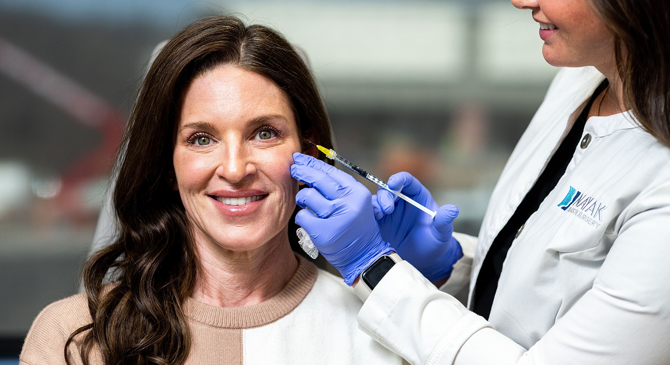 Patient receiving cosmetic injection from healthcare professional.