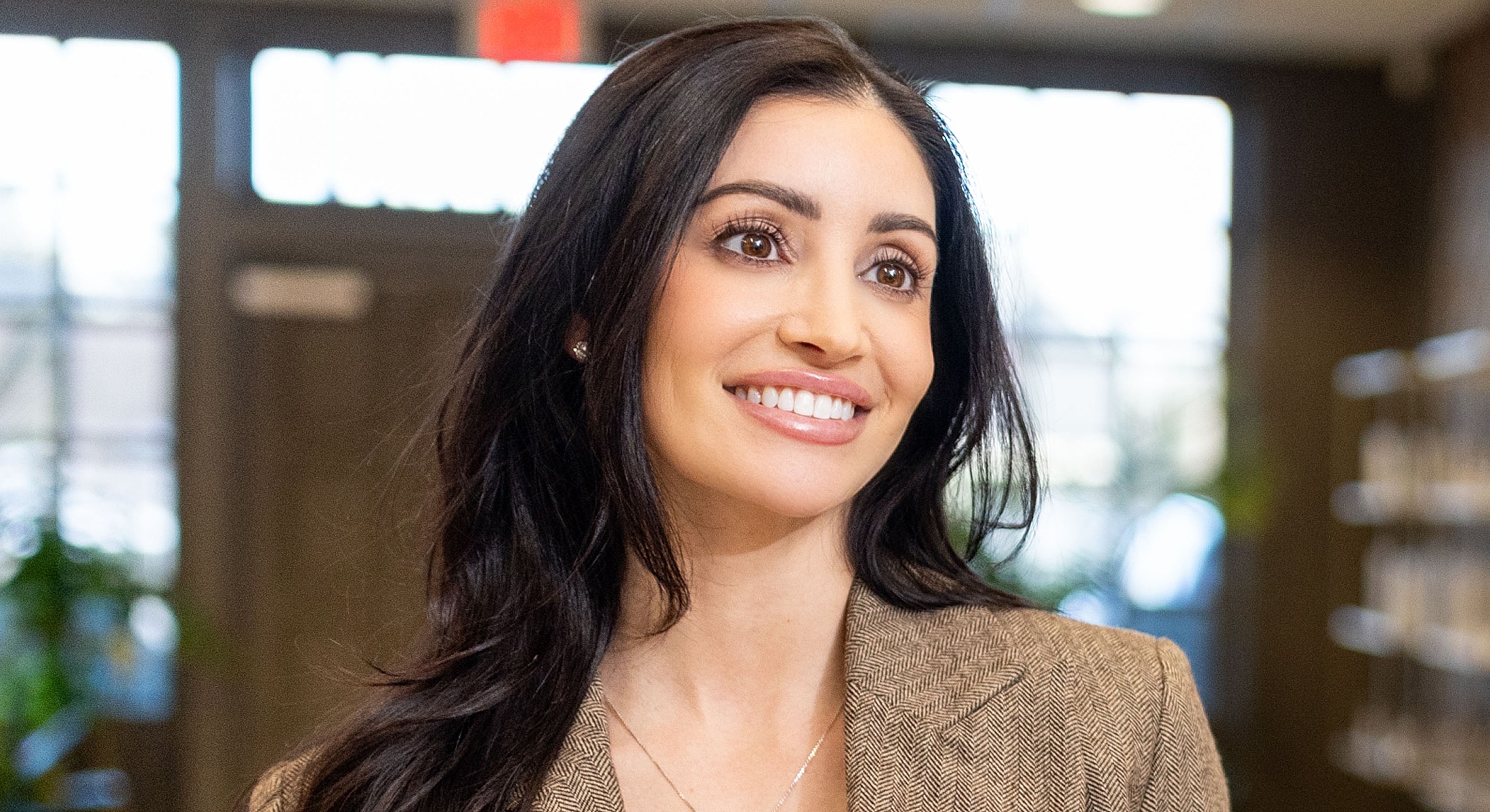 Smiling woman in a business setting.