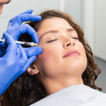 Attractive young woman is getting a rejuvenating facial injections