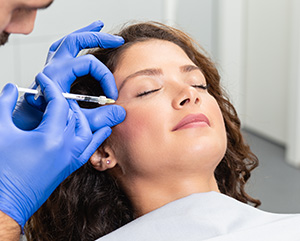 Attractive young woman is getting a rejuvenating facial injections